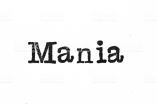 The word "Mania" from a typewriter on a white background